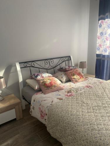 a bedroom with a bed with pillows on it at Rubinowe Apartamenty in Sandomierz