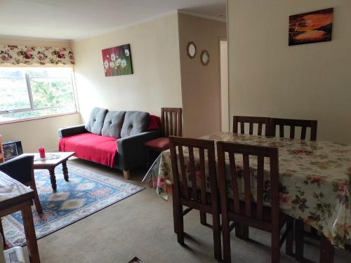 a living room with a couch and a table at DEPARTAMENTO COSTANERA PELLUCO, PUERTO MONTT in Puerto Montt