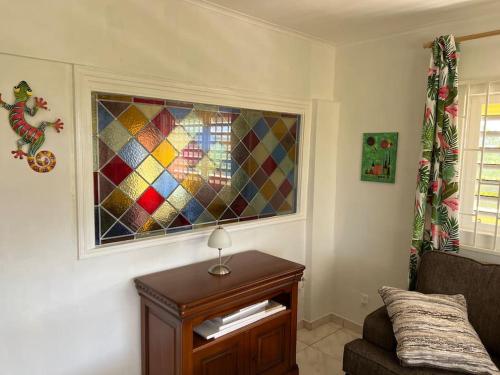 a living room with a couch and a stained glass window at Traumhaus am Hang mit privatem Pool in Barber