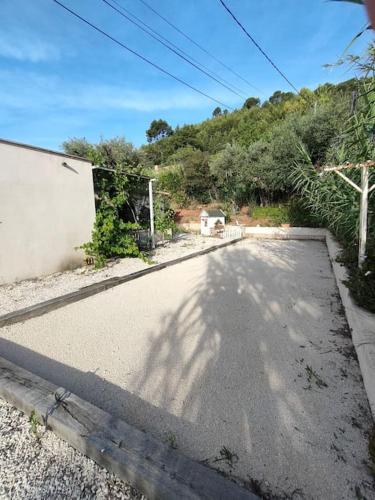 an empty road with a shadow of a tree at Emplacement idéal dans le Var ! in Cuers