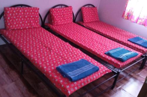 two beds in a room with red polka dots at Grace Homestay Kepayan in Kota Kinabalu