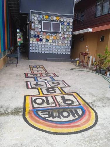 a painting on the ground in front of a building at Grace Homestay Kepayan in Kota Kinabalu
