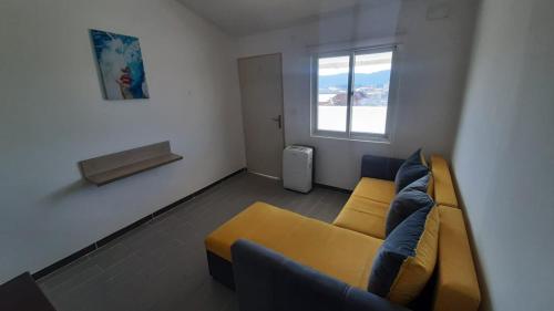 Boho Apart في بار: غرفة معيشة مع أريكة صفراء ونافذة