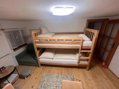 a bedroom with two bunk beds in a room at Chalupa U Franze in Malá Morava