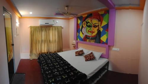 a bedroom with a bed with a painting on the wall at Beach Paradise Day Cruise Houseboat in Alleppey