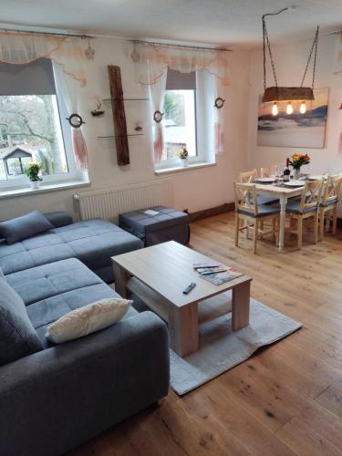 a living room with a couch and a table at Ferienwohnung 3 am Hofladen Hellendorf in Bad Gottleuba