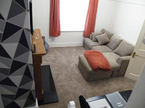 a living room with a couch and a chair at Family Home Near City Centre in Carlisle