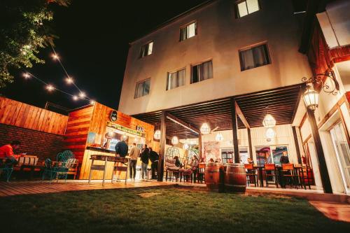 a group of people standing outside of a building at Gorilla Hostel in Mendoza