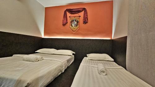 Postel nebo postele na pokoji v ubytování Hogwart's Guesthouse