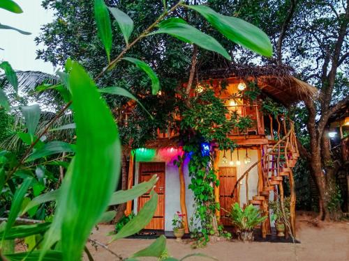 a house decorated with plants and lights at The Banda' Eco Villa in Sigiriya