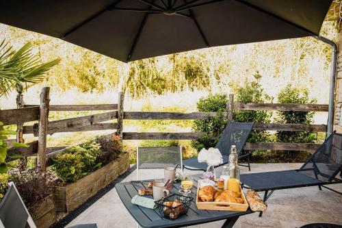 a table with a tray of food on a patio at Gites spa de charme L ETOILE SPA in Beynac-et-Cazenac
