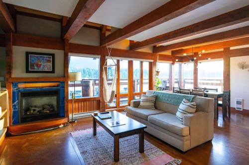 a living room with a couch and a fireplace at Waterfront Condo in Ucluelet in Ucluelet
