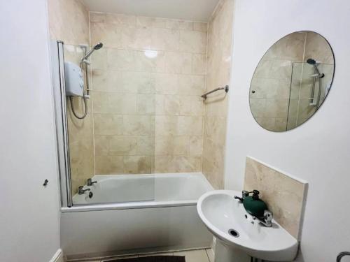 a bathroom with a shower and a sink and a tub at Cosy Studio near the City Centre in Liverpool