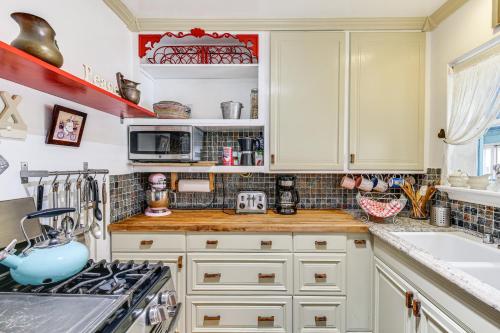 a kitchen with white cabinets and a stove at Gardena Vacation Rental 5 Mi to Manhattan Beach! in Gardena