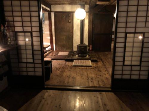 a view of a room with a door and a mirror at KOMINKA guest house in Omachi