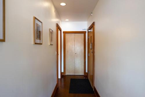 a hallway with a door and a rug at Waterfront Condo in Ucluelet in Ucluelet