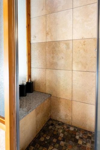 a bathroom with a tiled wall and a counter at Waterfront Condo in Ucluelet in Ucluelet