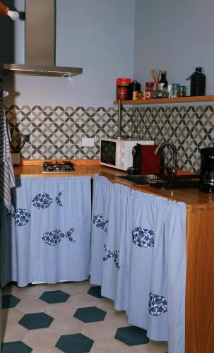 a kitchen with a counter with blue and white towels at La Grigua blu in Riomaggiore