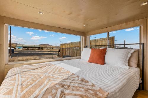 ein Schlafzimmer mit einem Bett und einem großen Fenster in der Unterkunft Tiny home near Grand Canyon sleeps 5, epic views! in Flagstaff