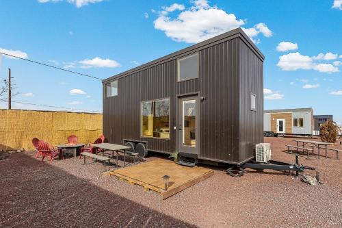 a black tiny house with a table and chairs at Tiny home near Grand Canyon sleeps 5, epic views! in Flagstaff
