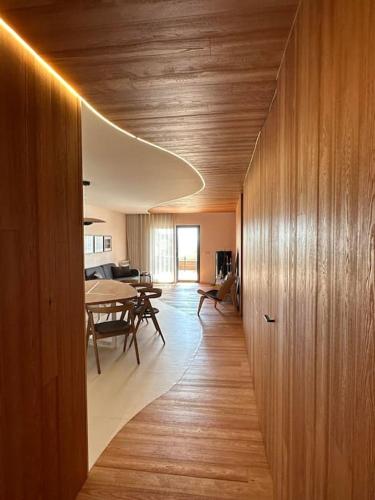 a living room with a table and a dining room at Feel the Ocean Design Apartment in Pataias