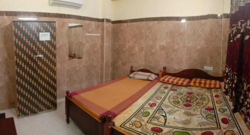 a bedroom with a bed and a shower at VIMAL RESIDENCY in Vellore