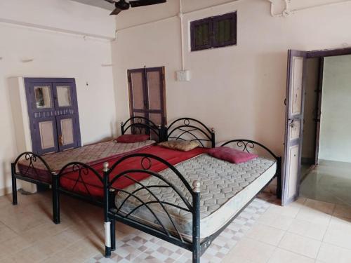 a bedroom with two beds in a room at SS GUEST HOUSE & PG in Kumbakonam