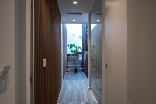 a hallway with a room with a plant in it at HOTIDAY Room Collection - Olbia Wallure in Olbia