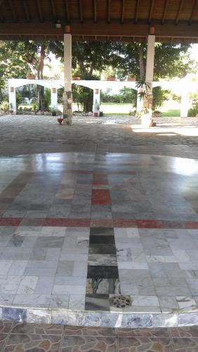 a checkered floor in a building with a gazebo at Hotel Tropicana Santo Domingo in La Viva