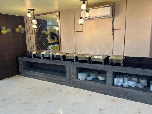 a kitchen with a counter with white dishes on it at HOTEL IMPERIAL in Aurangābād