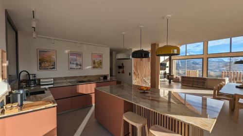 a kitchen with a large island with a counter top at Chalet Coste Belle in La Fare-en-Champsaur