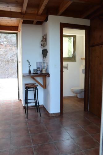 a bathroom with a toilet and a stool in a room at Auberge Kalopetri in Kamiros