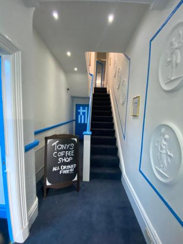 a staircase in a building with a sign on it at The New Athena Hotel in Blackpool