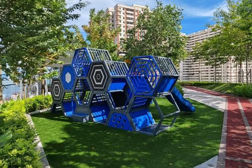 a blue sculpture on the grass in a park at Cityscape Haven - Urban Suites by Ocean Luxe in Jelutong