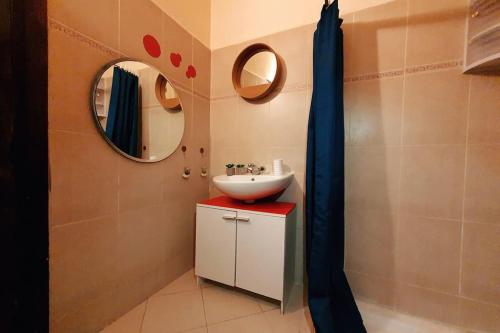 a bathroom with a sink and a mirror at Nice 2 BR flat - L'Appart'215- Agadir in Agadir