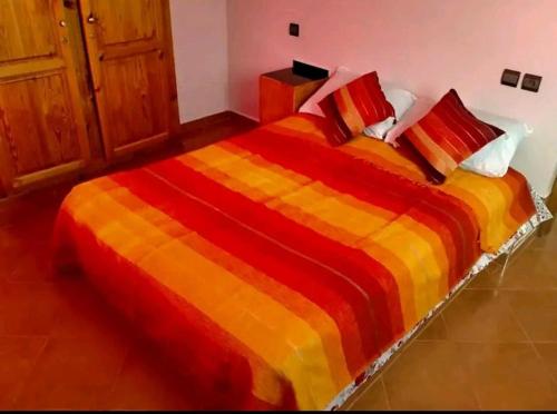 a bedroom with a large bed with a colorful blanket at Titanic House by ahmed in Mirleft