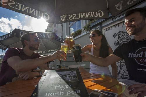 a group of people sitting at a table with drinks at Hajo´s Germania Lodge & Irish Pub in Rüdesheim am Rhein