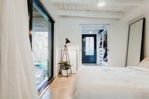 a bedroom with a bed and a large window at Le Duplex St-Sauveur, Maison entière in Quebec City