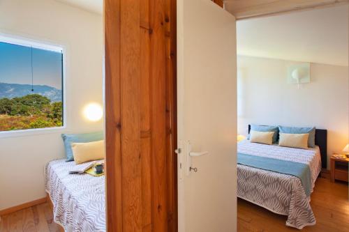 a bedroom with two beds and a window at Residence Agula Mora in Lecci