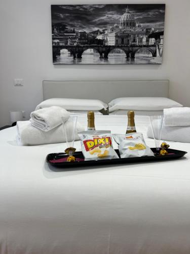 a tray with two bottles of beer on a bed at Roma Mia in Trastevere in Rome