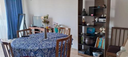 a dining room table with a vase of flowers on it at Borde Mar Costa Papudo in Papudo