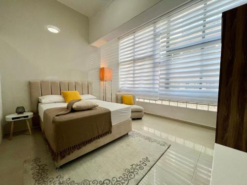 een slaapkamer met een bed en een groot raam bij Blue Sea Studio 1 minute away from Luanda Bay in Luanda