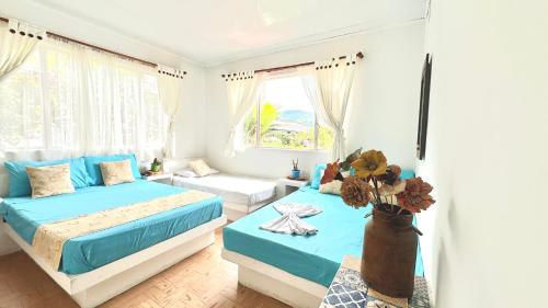 een slaapkamer met 2 bedden en een raam bij Finca Hotel Villaruth in Apulo