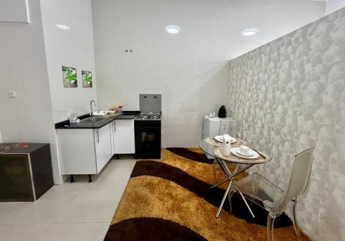 a kitchen with a small table and a sink at Blue Sea Studio 1 minute away from Luanda Bay in Luanda