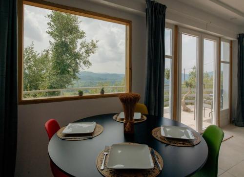 a dining room with a table and a large window at Olympian Heights in Olympia