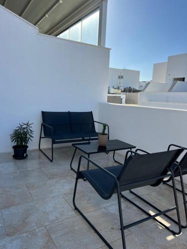two chairs and a table in a room at Bright Penthouse with large terrace in Pieta