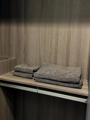 two towels sitting on a shelf in a room at HMJ2 Entire Apt on 34th floor in Khonkaen city center in Ban Si Than