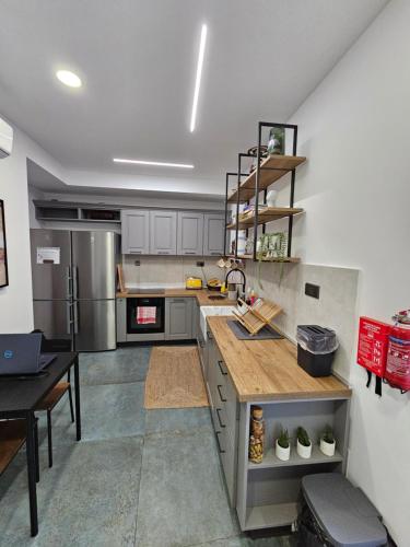 a kitchen with a sink and a counter top at Dahlia apartment - Paola Modern Townhouse in Paola