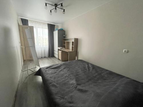 a bedroom with a bed and a ladder in it at Vironia Apart in Kohtla-Järve