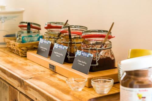a shelf with jars of jam on a counter at Babelfish Hostel in Würzburg
